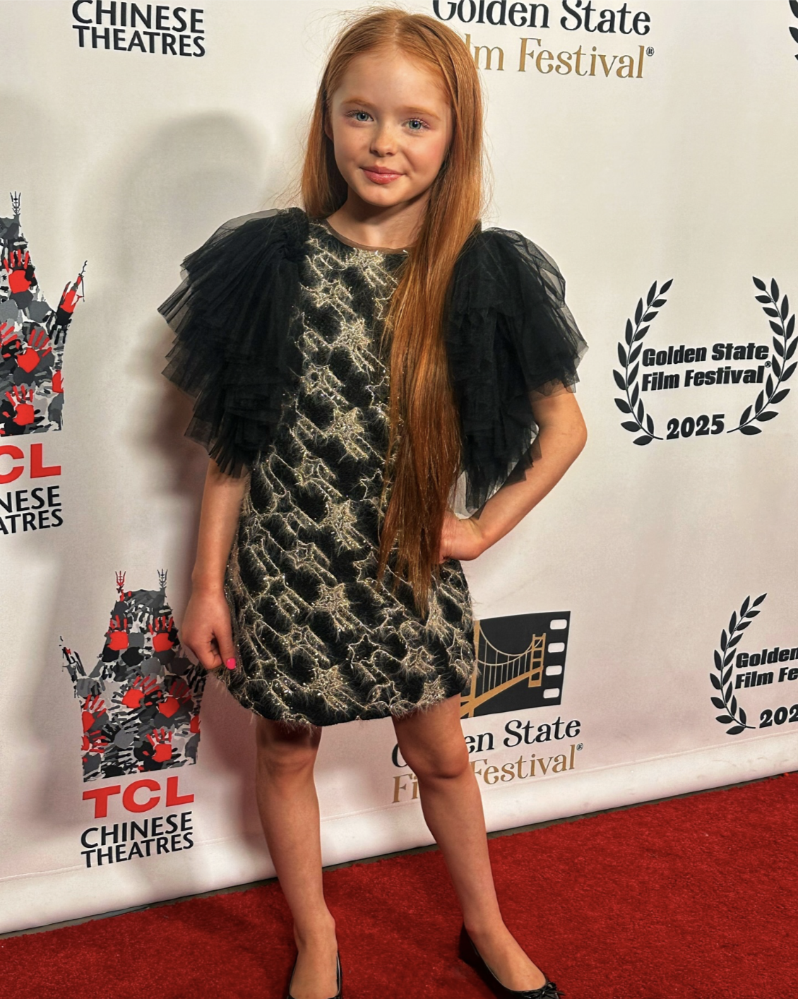 Kynlee is wearing Sonata Tulle Sleeve Tweed Mini Black Dress